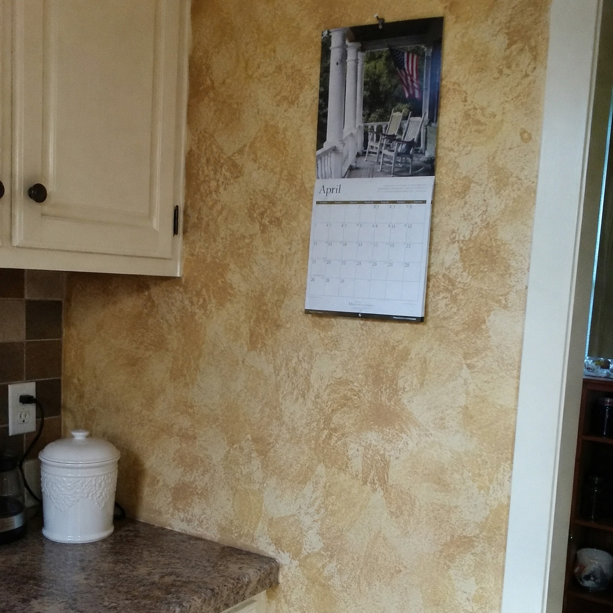 Sponge-painted or faux-finished beige walls