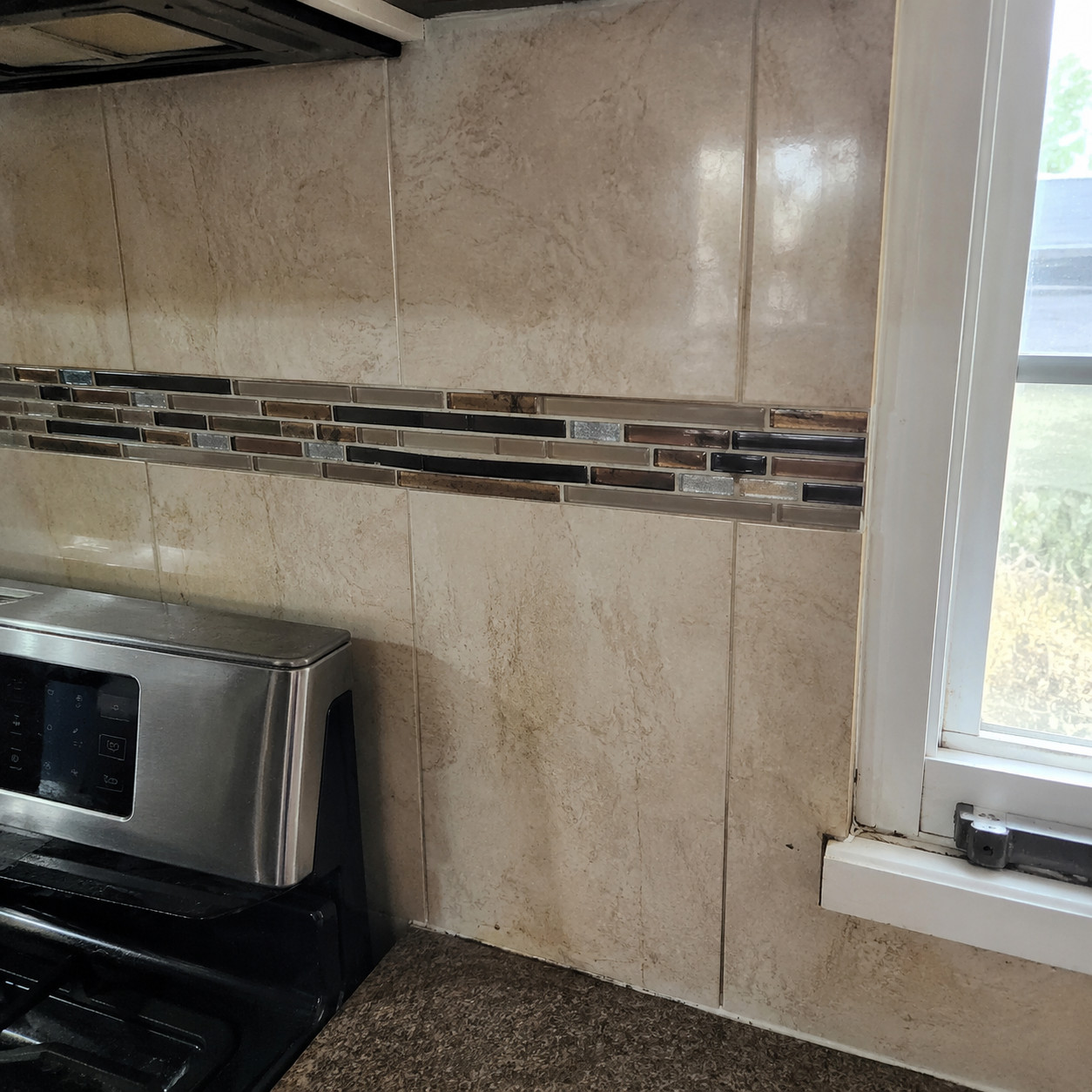 Glass mosaic accent strip backsplash
