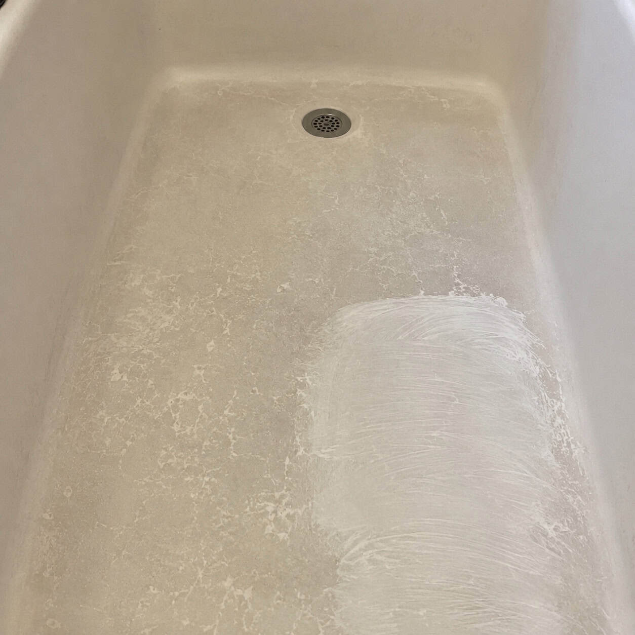 A Dingy, Stained Fiberglass Tub or Shower Floor