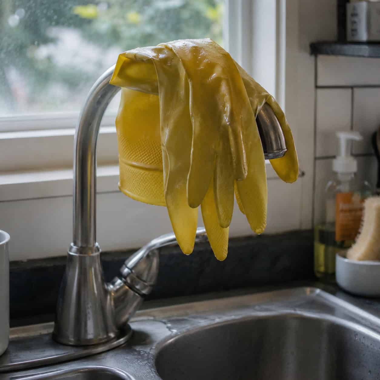 Rubber Gloves Draped Over the Faucet