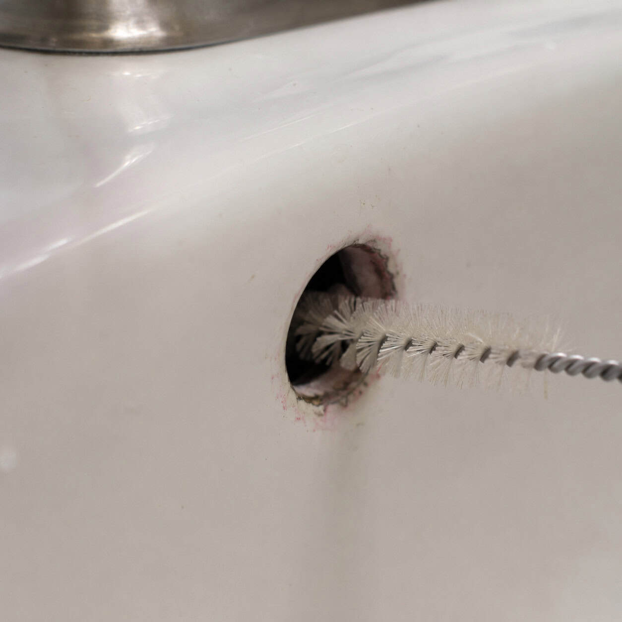 Pink or Black Gunk in the Sink Overflow Hole