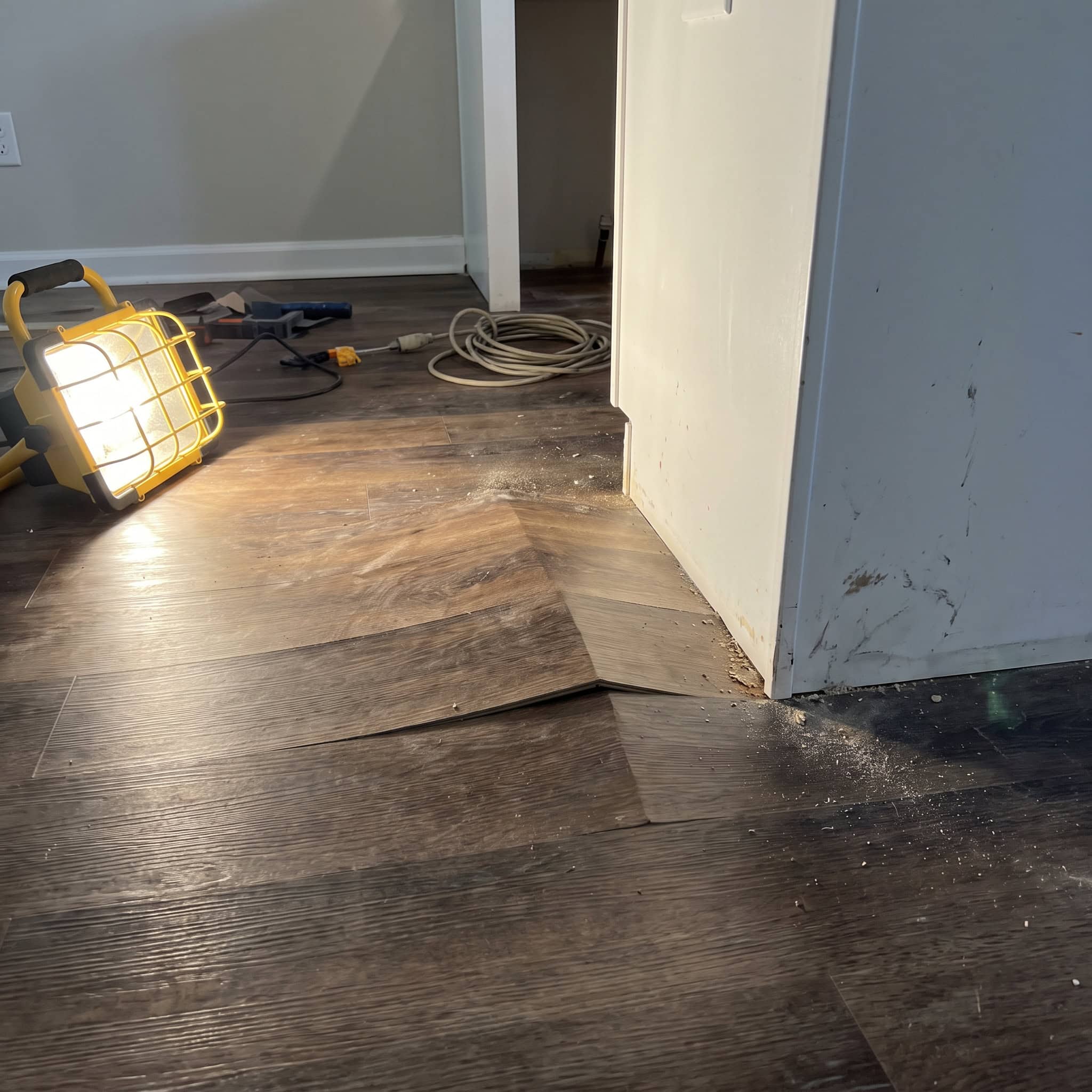 A Floating Floor Pinned Under Cabinets and the Island