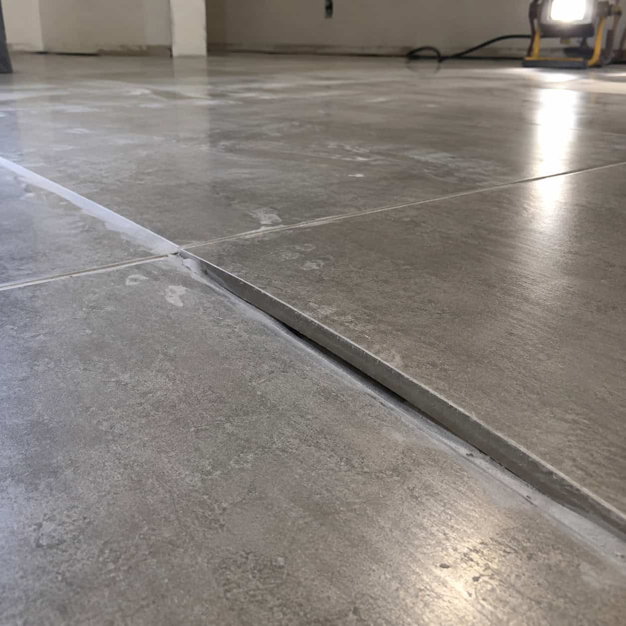 Large-format tile on a floor nobody flattened