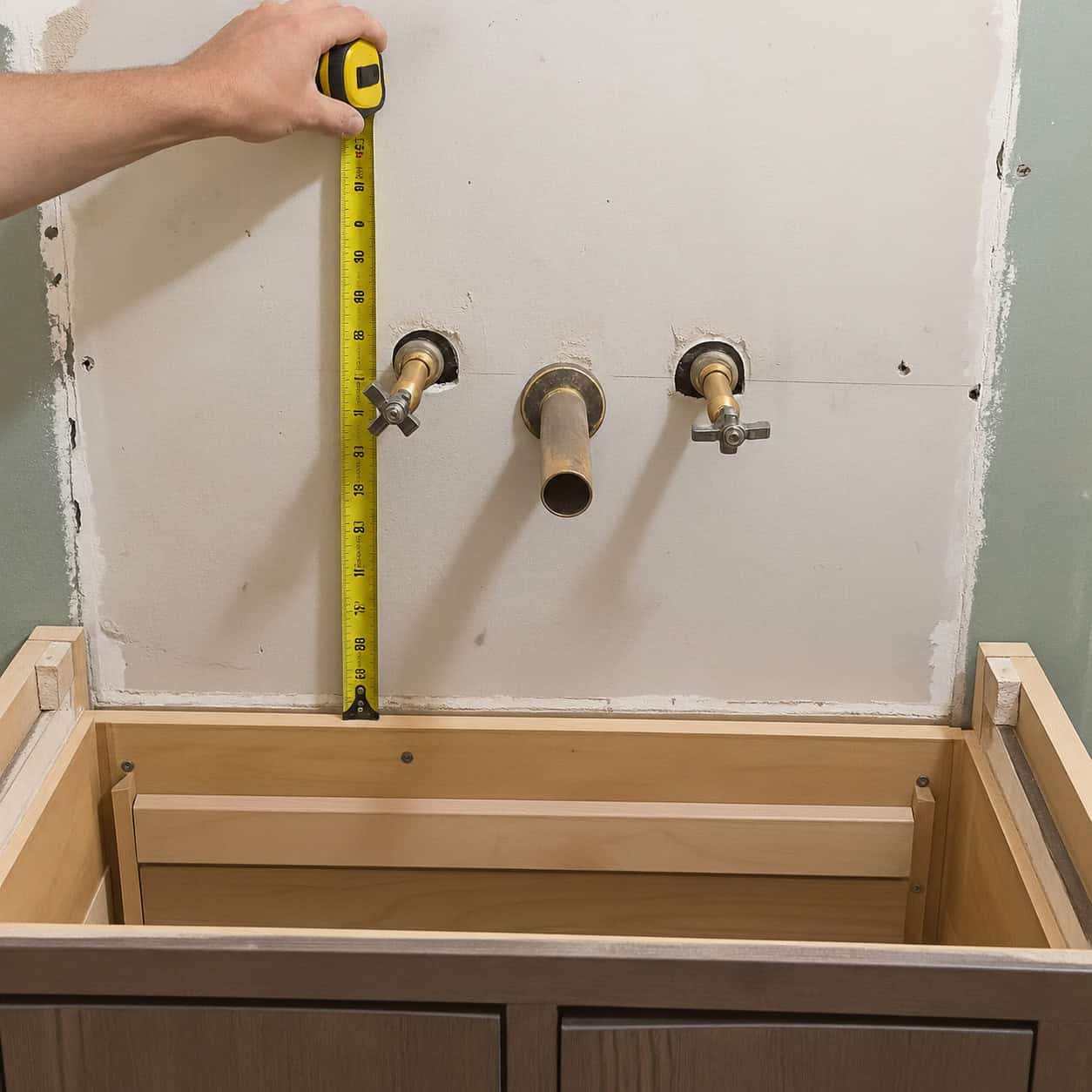 A wall-mounted faucet roughed in blind