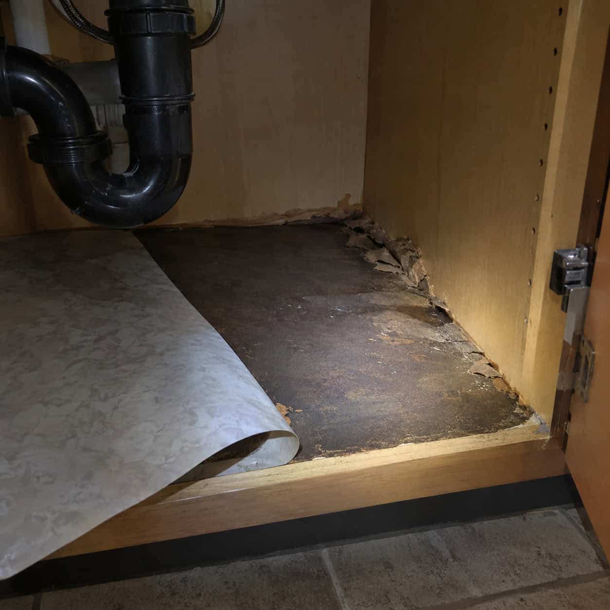 The swollen floor of the sink base cabinet